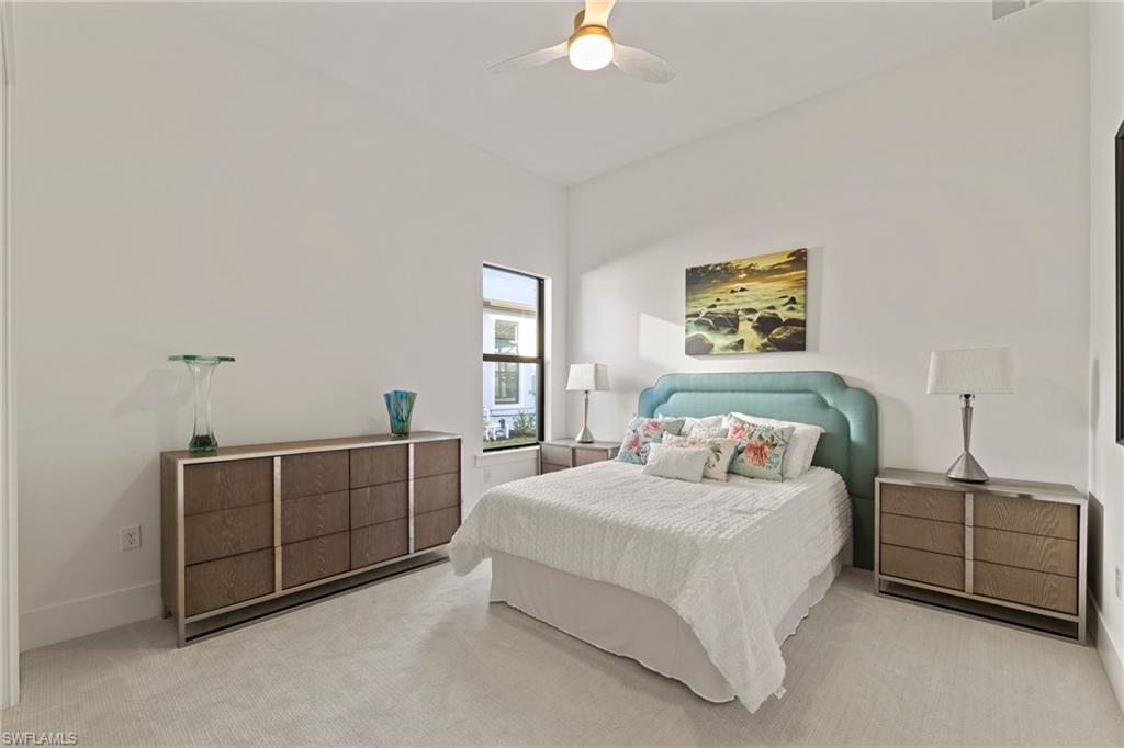 16140 Verilyn Circle Naples, FL 34110 - Photo 21 of 44 a bedroom with a bed and a cabinets