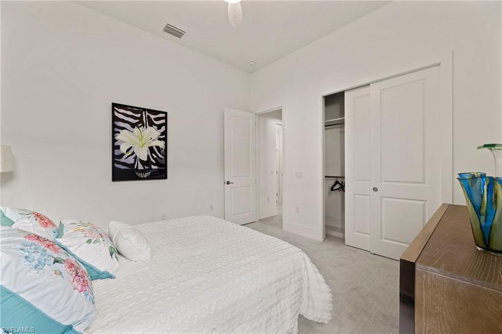 16140 Verilyn Circle Naples, FL 34110 - Photo 22 of 44 a bedroom with a bed and a cabinets