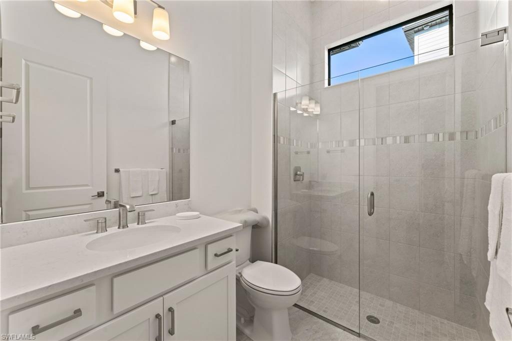 16140 Verilyn Circle Naples, FL 34110 - Photo 23 of 44 a bathroom with a sink a toilet and shower