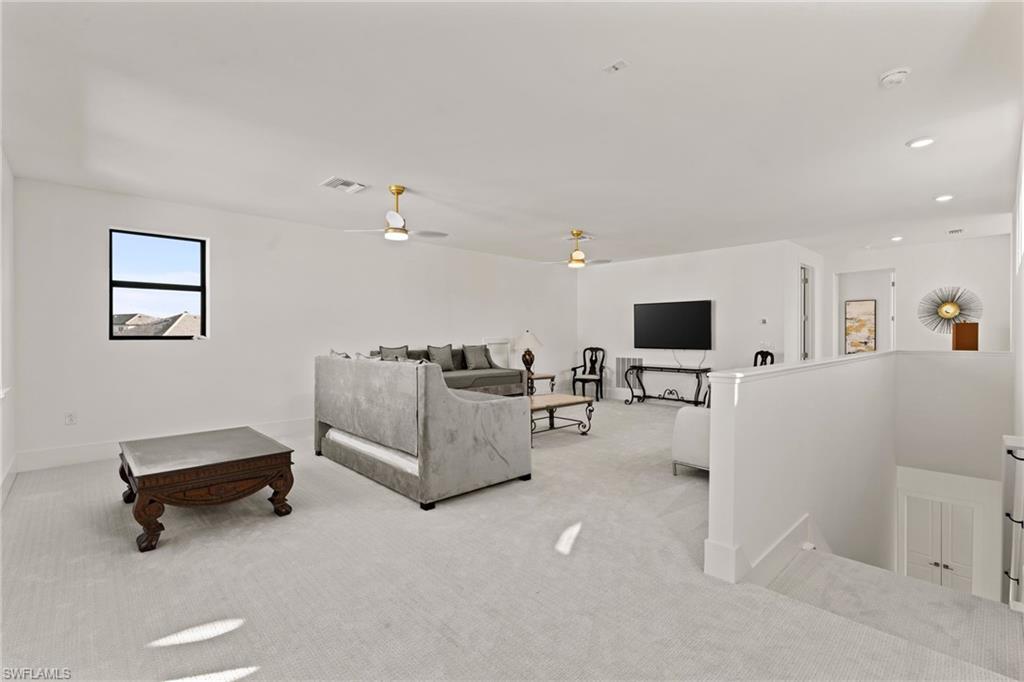 16140 Verilyn Circle Naples, FL 34110 - Photo 27 of 44 a living room with furniture and a flat screen tv