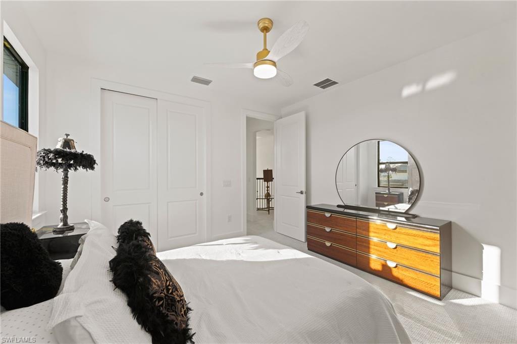 16140 Verilyn Circle Naples, FL 34110 - Photo 31 of 44 a bedroom with a bed and a chandelier