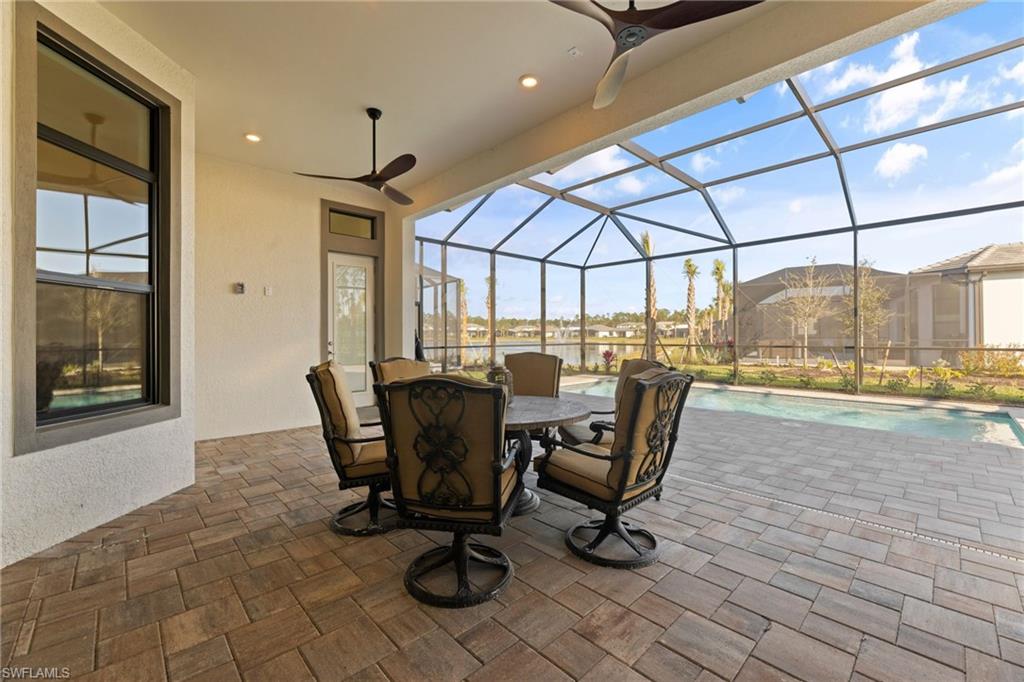 16140 Verilyn Circle Naples, FL 34110 - Photo 35 of 44 a dining room with furniture and a floor to ceiling window