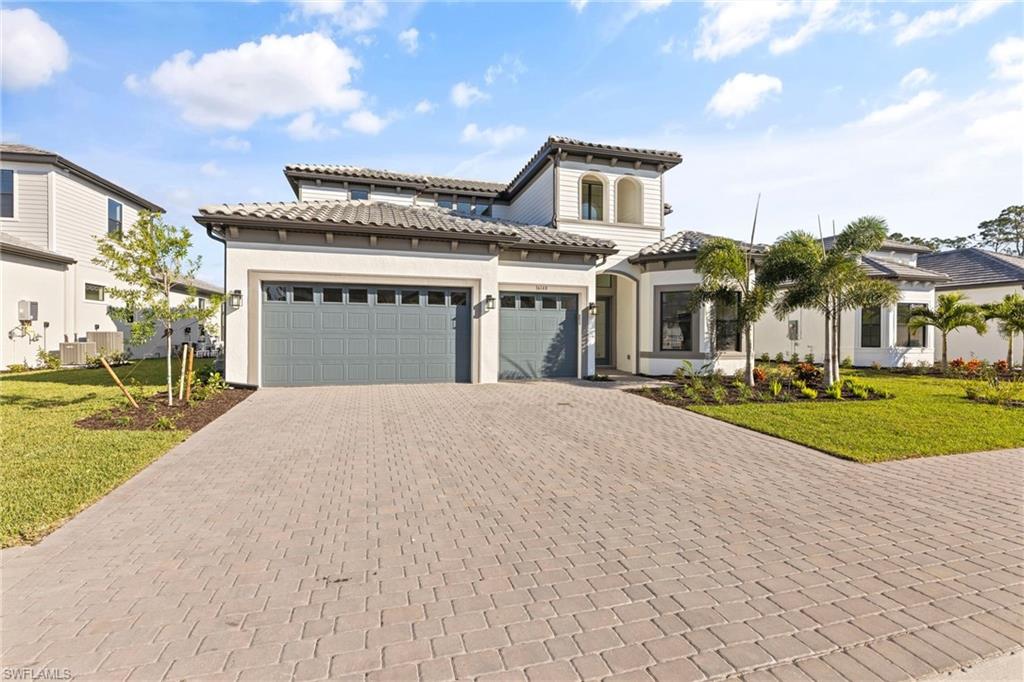 16140 Verilyn Circle Naples, FL 34110 - Photo 42 of 44 a front view of a house with a yard