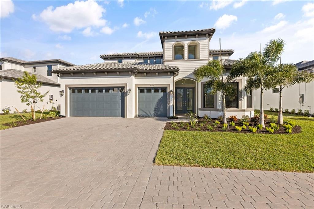 16140 Verilyn Circle Naples, FL 34110 - Photo 43 of 44 a front view of a house with garden