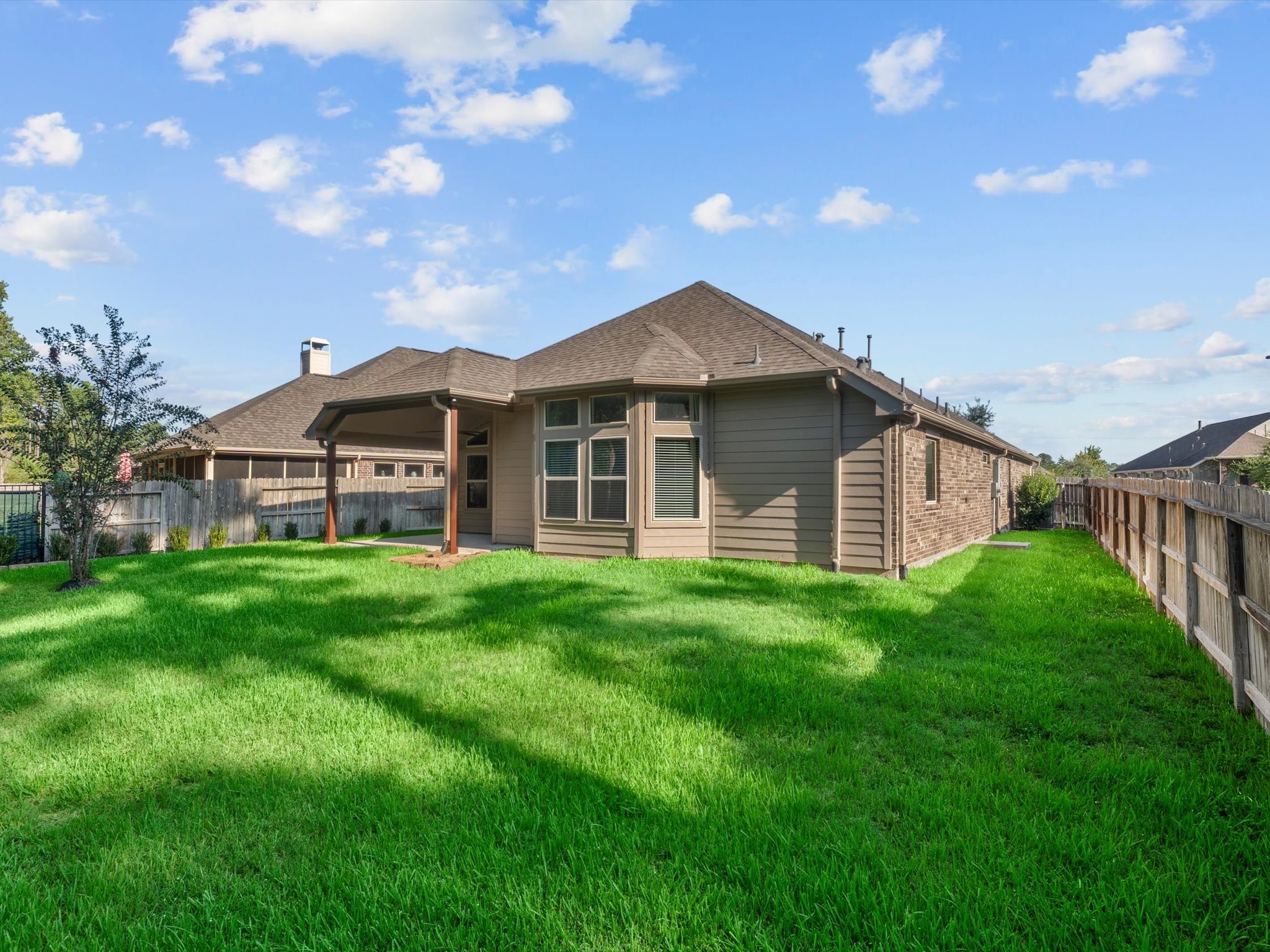 4746 Misty Ranch Drive Spring, TX 77386 - Photo 46 of 49 Freshly repainted exterior in 2026, complete with a covered back patio for entertaining or grilling, no back neighbors for added privacy, and gutters. Fully Fenced.