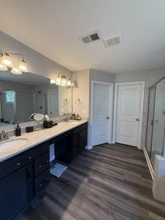 a spacious bathroom with a double vanity sink and a mirror