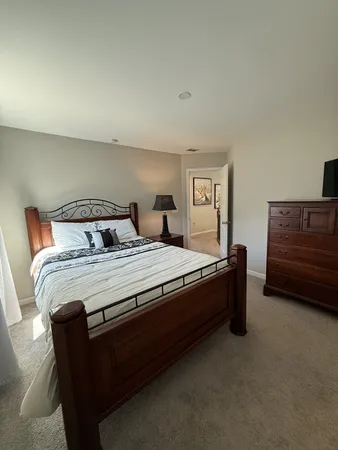 a bedroom with a bed and dresser