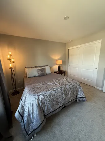 a bedroom with a bed and lamp