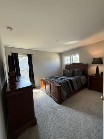 a spacious bedroom with a bed and window