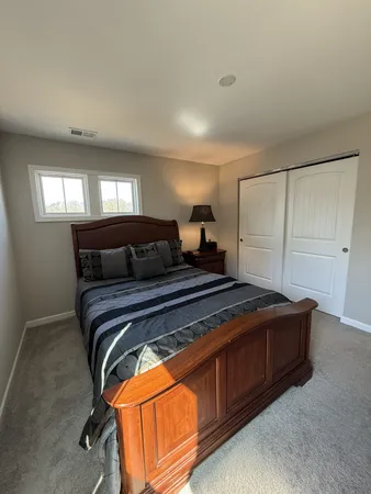 a bedroom with a bed and window