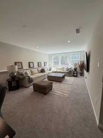 a living room with lots of furniture and a lamp