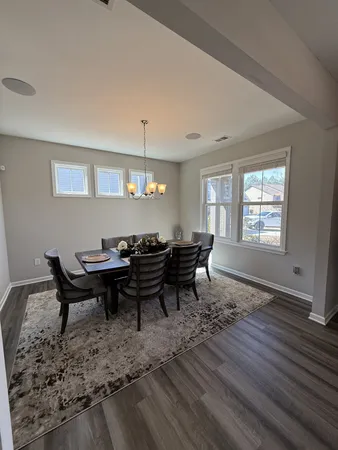 a view of a dining room with a table and chairs