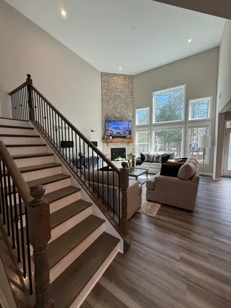 a living room with furniture or wooden floor and windows