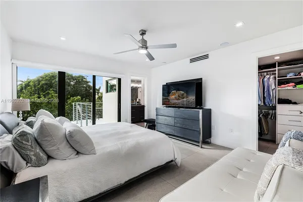 a bedroom with a large bed and a flat screen tv