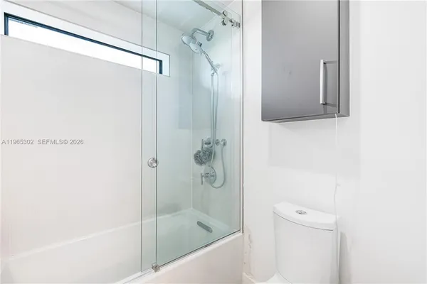 a bathroom with a shower and toilet