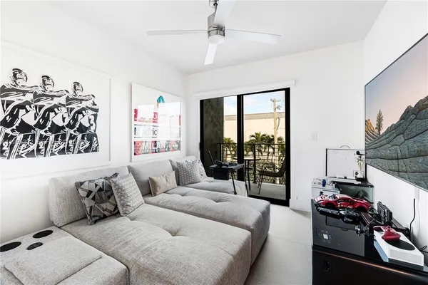 a living room with furniture and a floor to ceiling window