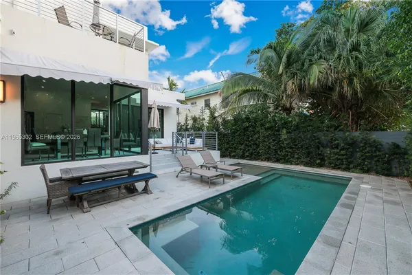 a view of a patio with swimming pool table and chairs