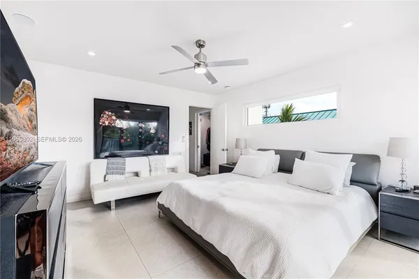 a bedroom with a bed and a flat screen tv