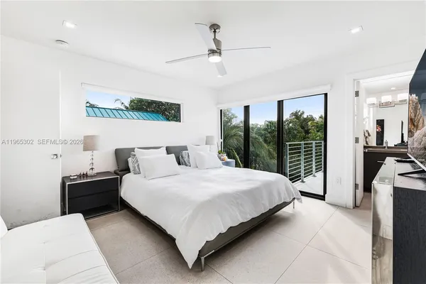 a bedroom with a large bed and a window