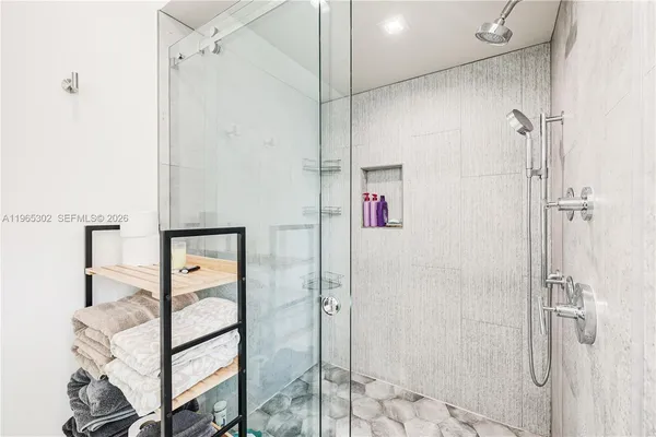 a bathroom with a shower and a sink