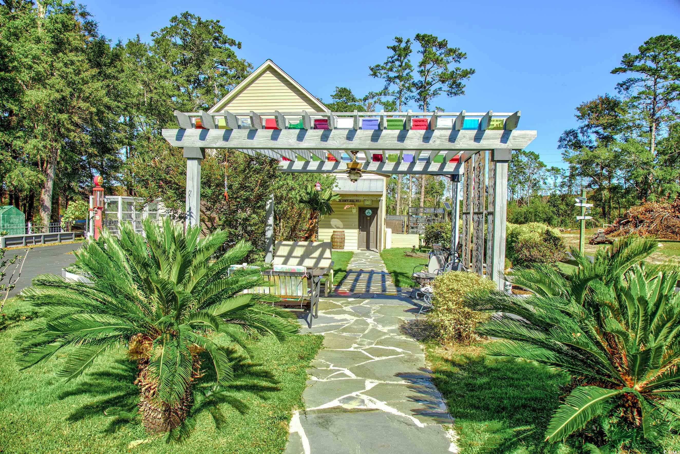 3637 Choppee Road Georgetown, SC 29440 - Photo 11 of 40 View of home's community featuring a pergola and a patio