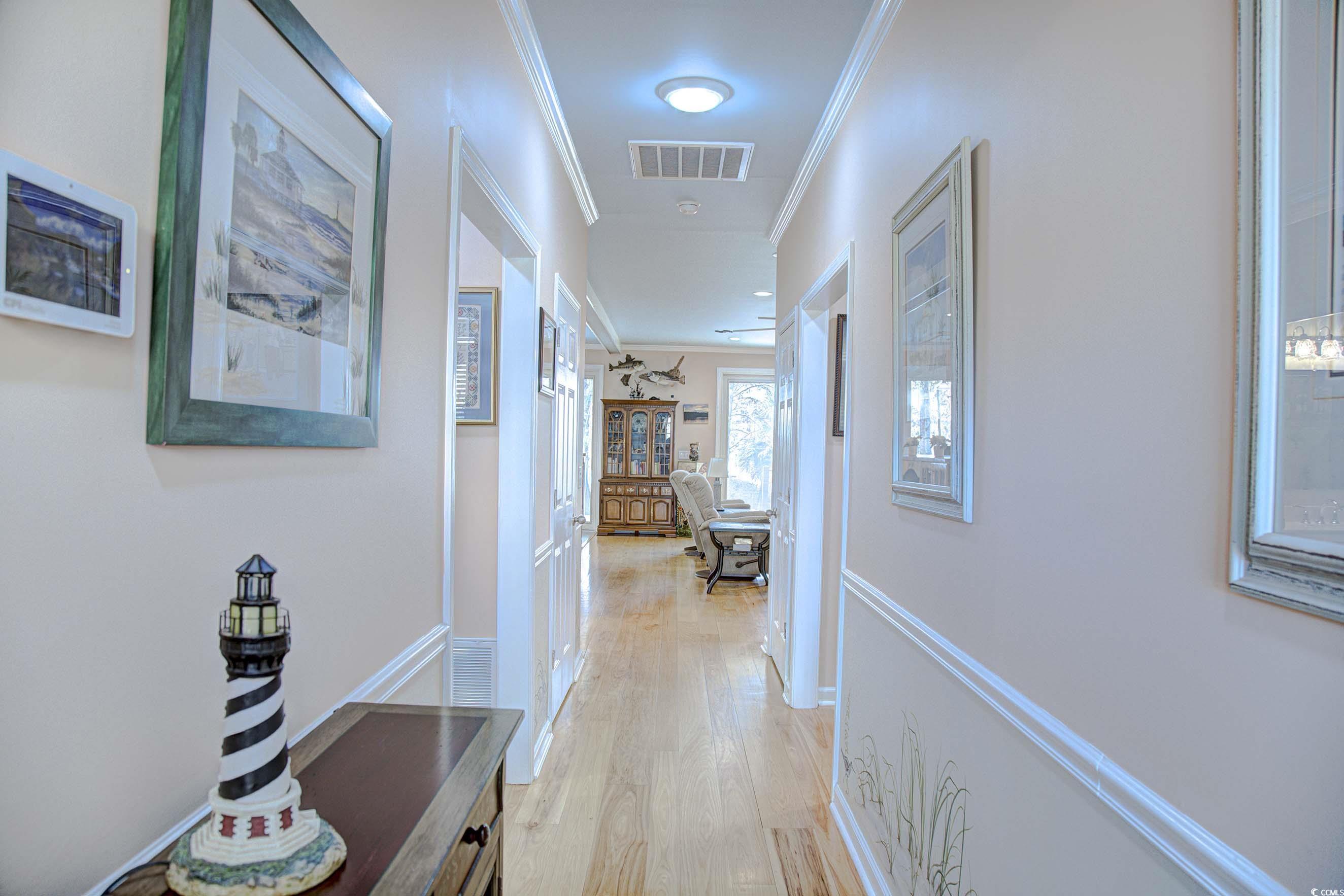 3637 Choppee Road Georgetown, SC 29440 - Photo 12 of 40 Corridor with crown molding and light wood-type flooring