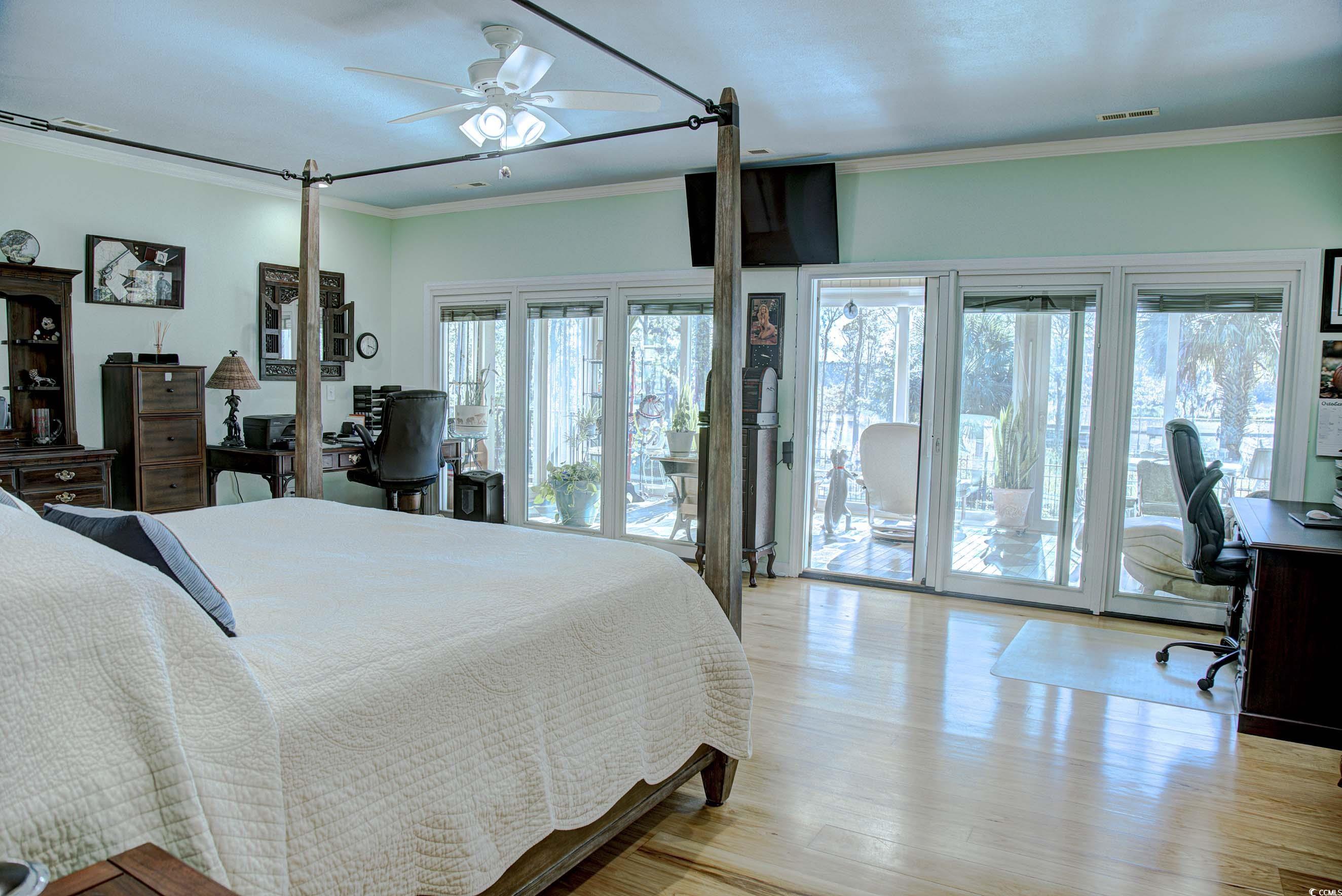 3637 Choppee Road Georgetown, SC 29440 - Photo 18 of 40 Bedroom featuring a desk, ornamental molding, ceiling fan, access to outside, and light wood-style floors
