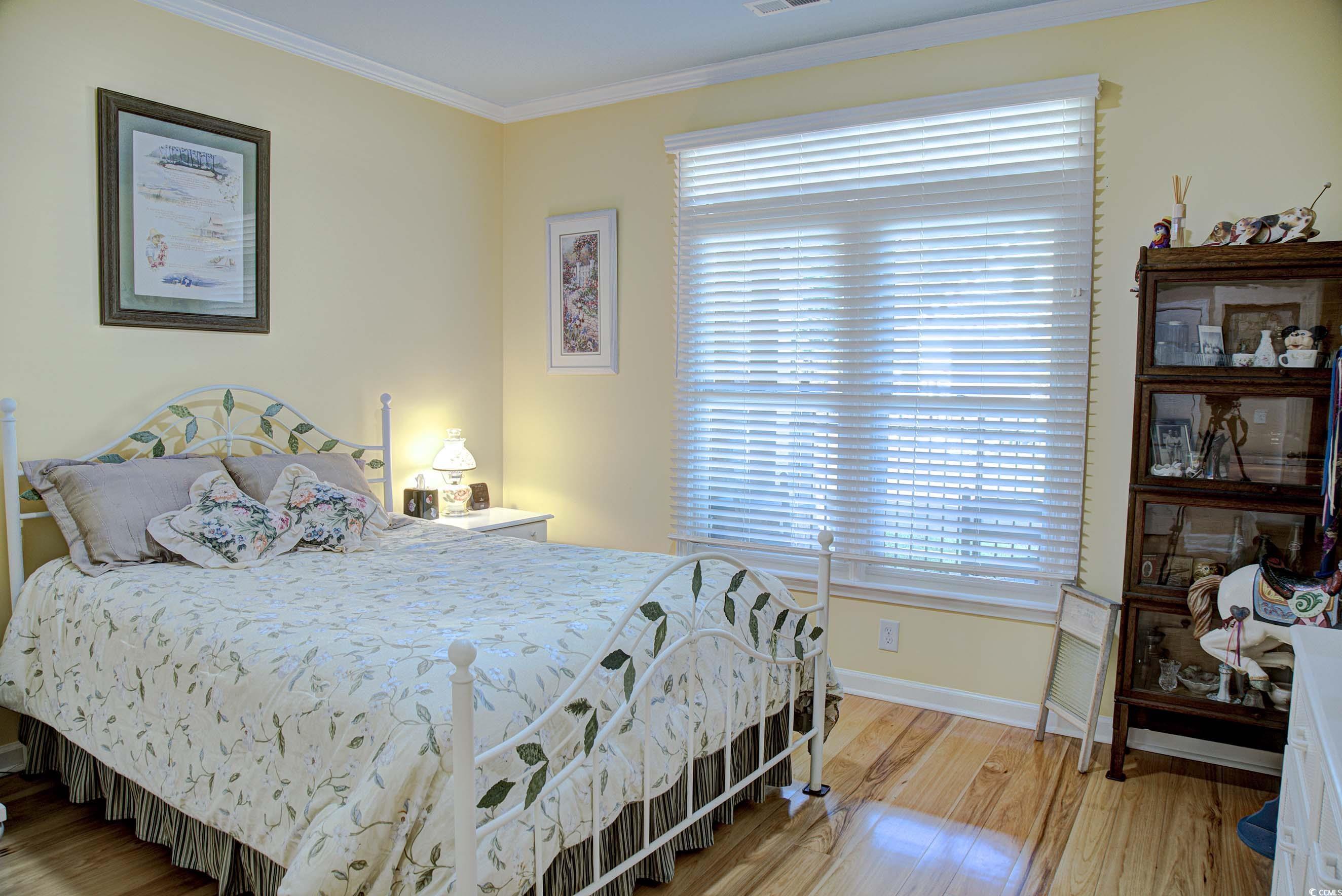 3637 Choppee Road Georgetown, SC 29440 - Photo 22 of 40 Bedroom with crown molding and light wood-type flooring