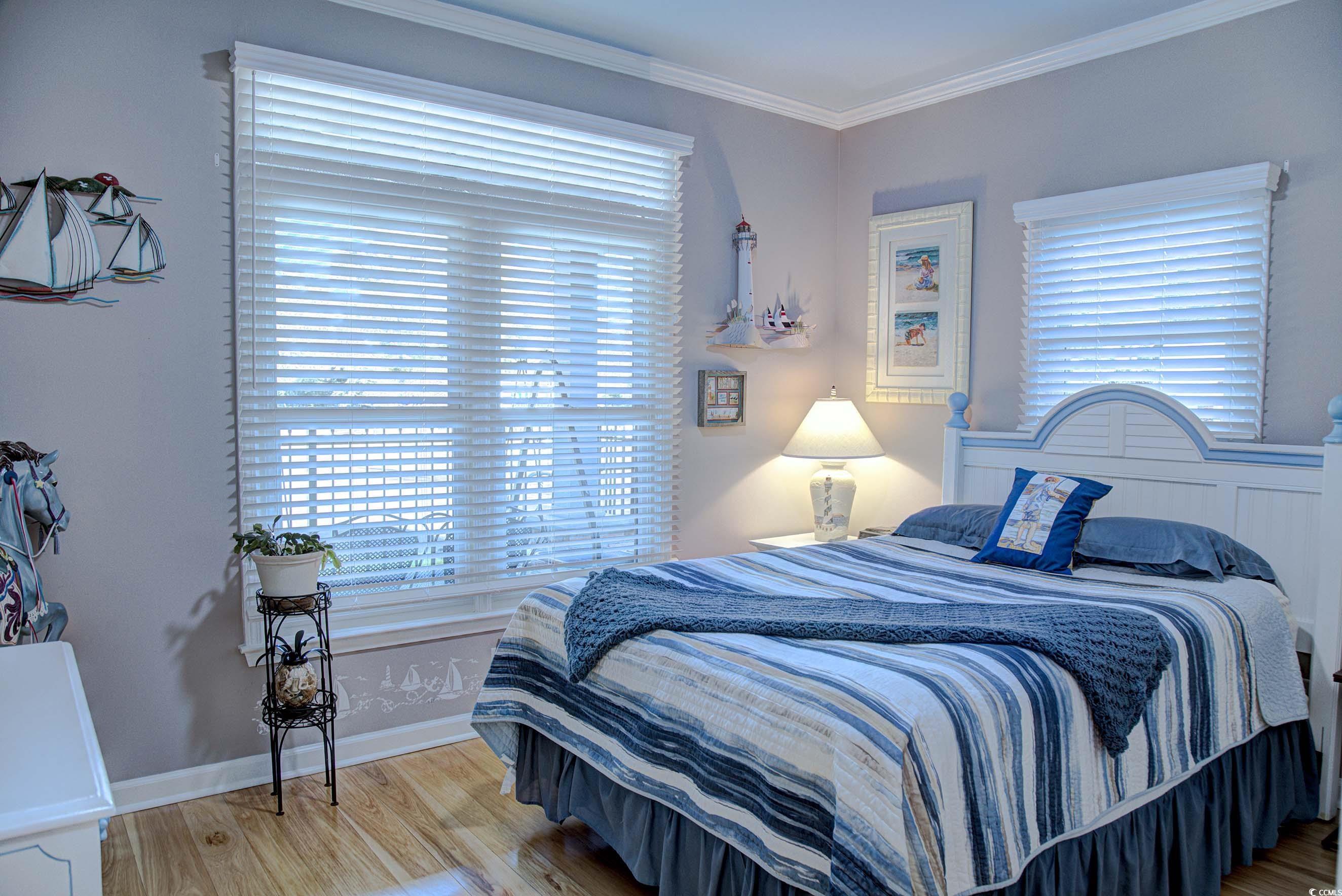 3637 Choppee Road Georgetown, SC 29440 - Photo 24 of 40 Bedroom with ornamental molding and wood finished floors