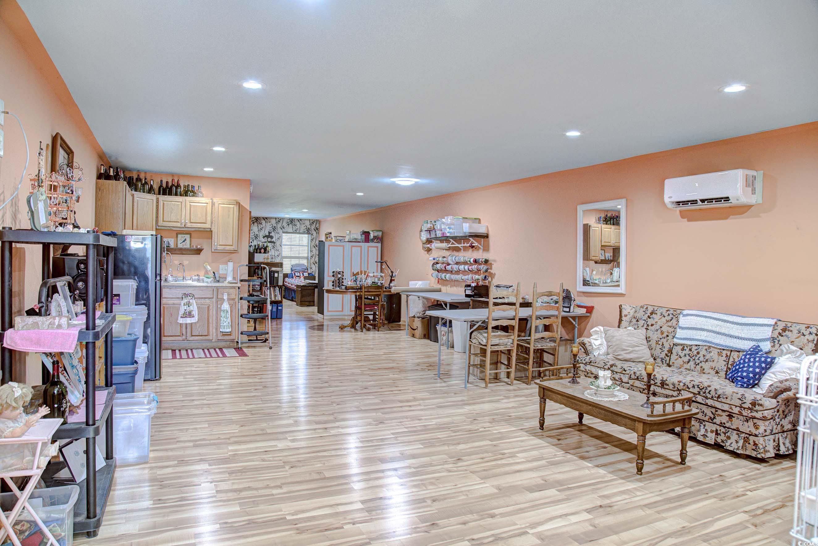 3637 Choppee Road Georgetown, SC 29440 - Photo 31 of 40 Living room with recessed lighting, light wood-style flooring, and an AC wall unit