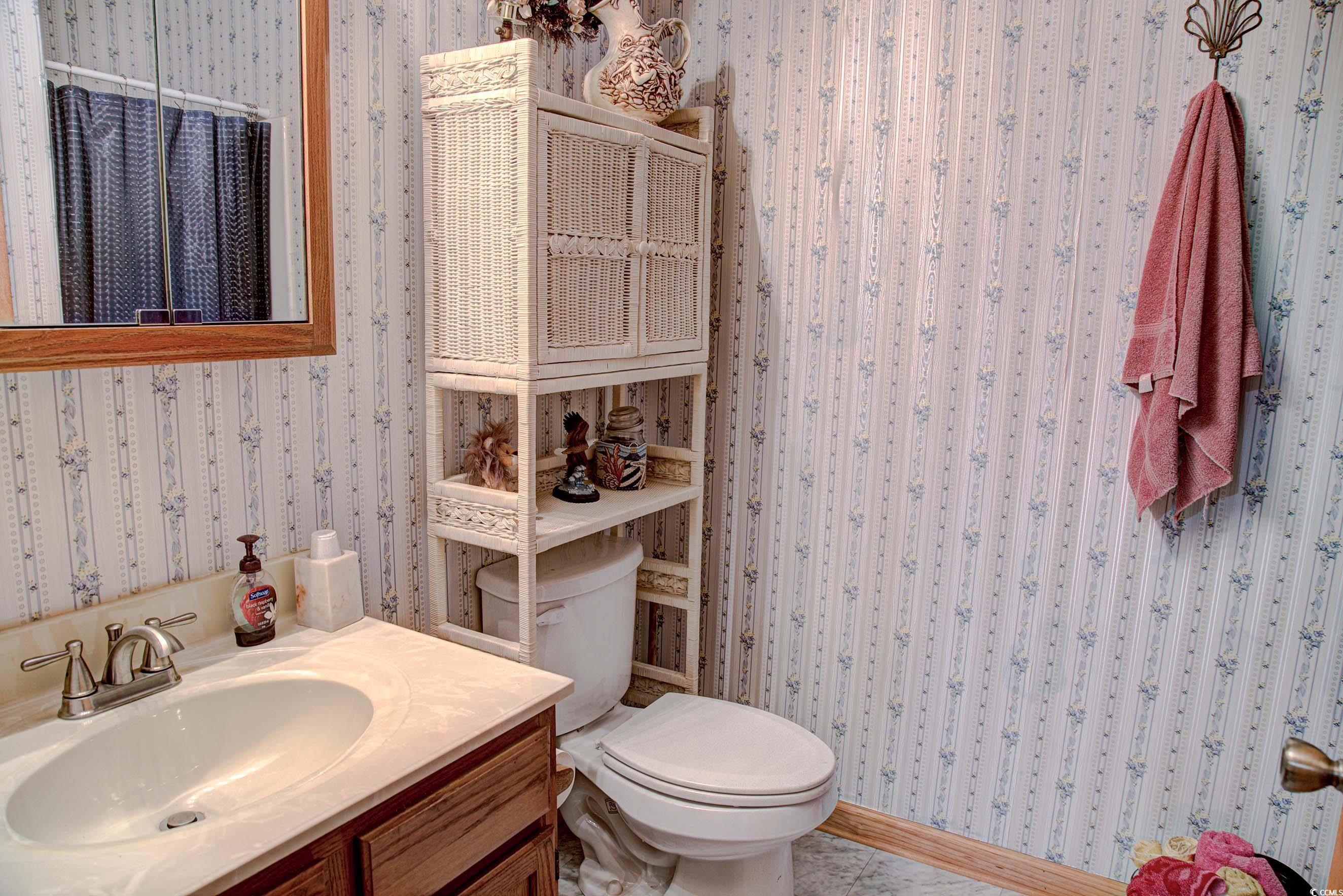 3637 Choppee Road Georgetown, SC 29440 - Photo 33 of 40 Bathroom with wallpapered walls and vanity