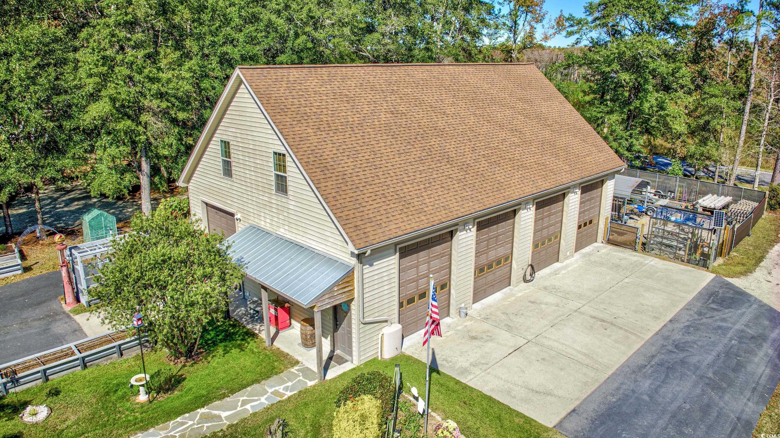 3637 Choppee Road Georgetown, SC 29440 - Photo 4 of 40 Drone / aerial view of garage showing bay doors, upstairs, and garage pads