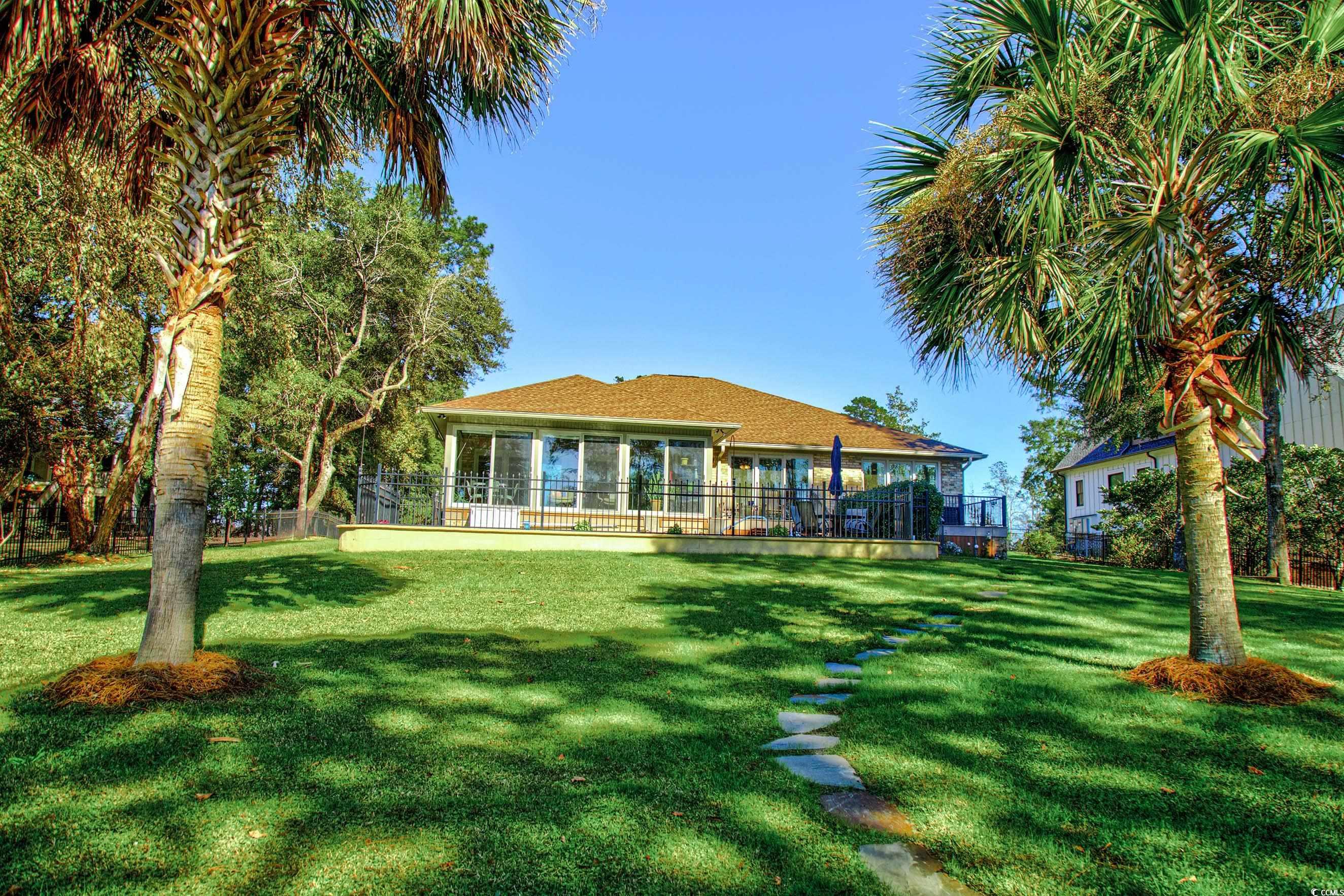 3637 Choppee Road Georgetown, SC 29440 - Photo 9 of 40 Rear view of property featuring a wooden deck and fencing.