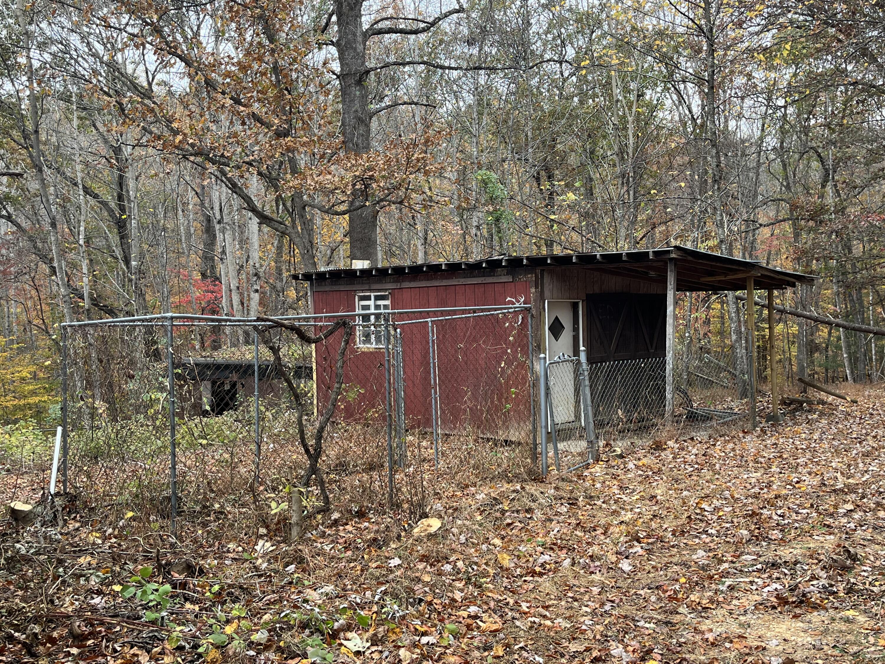 108 Meadowlark Road Blue Ridge, VA 24064 - Photo 3 of 14 a view of a barn with wooden fence and large trees