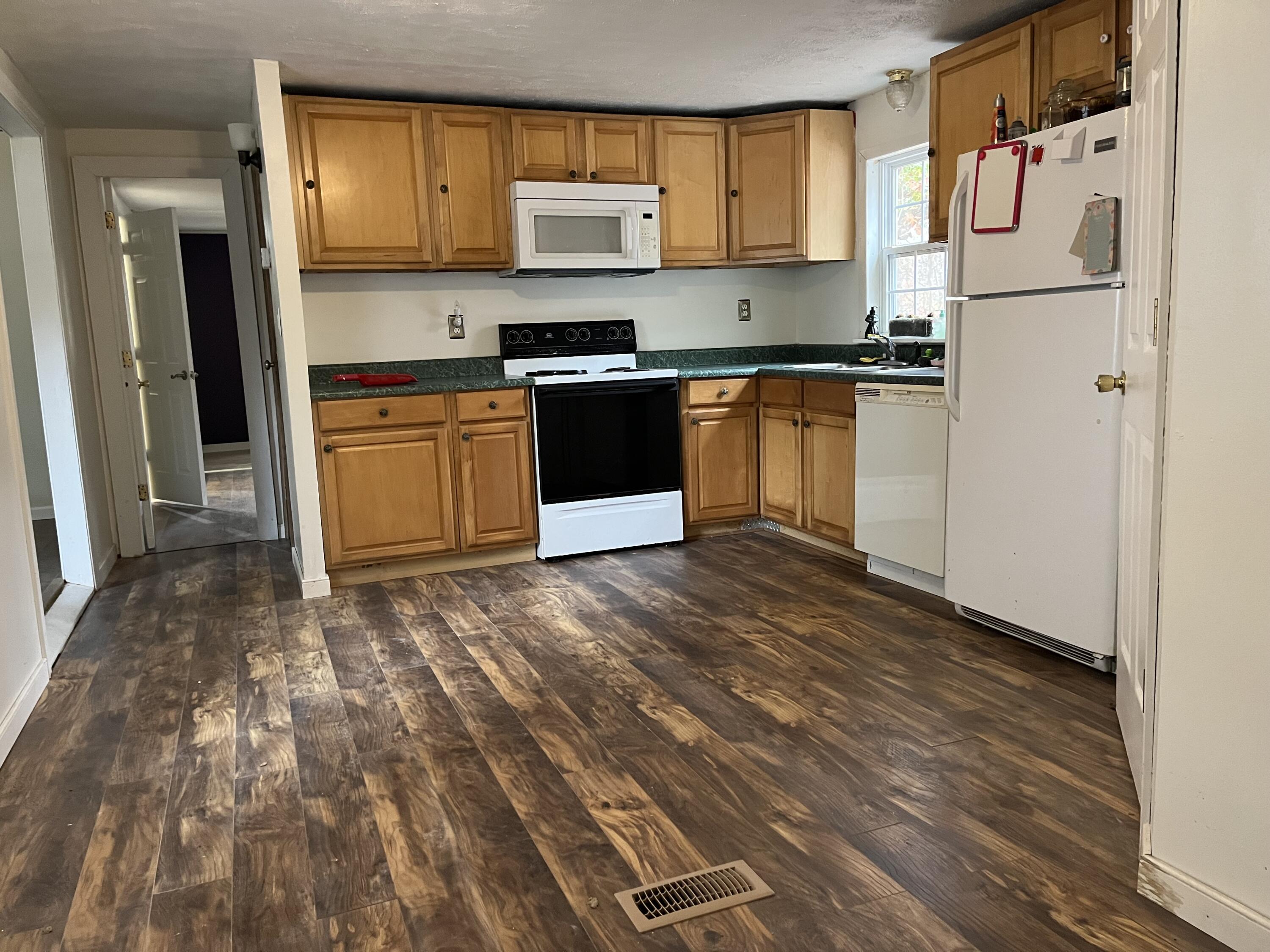108 Meadowlark Road Blue Ridge, VA 24064 - Photo 8 of 14 a kitchen with wooden cabinets and white appliances