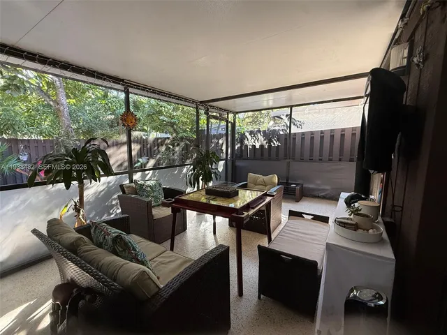 a living room with furniture and a floor to ceiling window