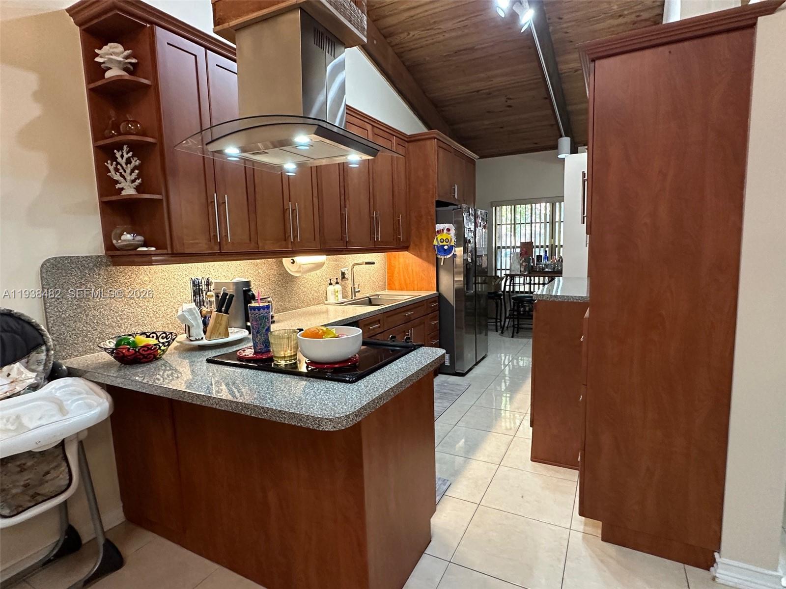 3415 Freedom Drive Hollywood, FL 33021 - Photo 15 of 49 a kitchen with stainless steel appliances granite countertop a sink stove and cabinets