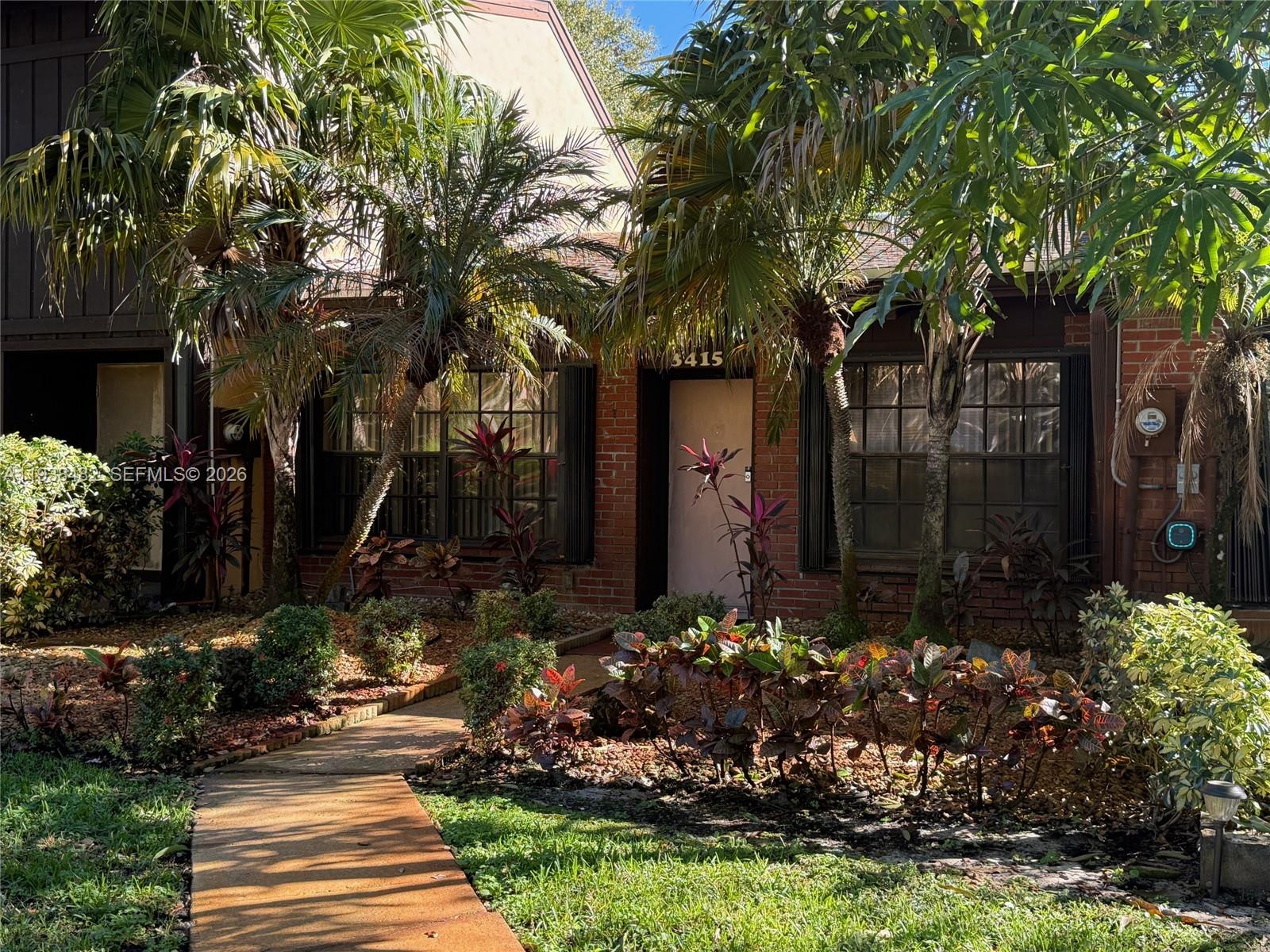 3415 Freedom Drive Hollywood, FL 33021 - Photo 2 of 49 a view of a house with a yard and garden