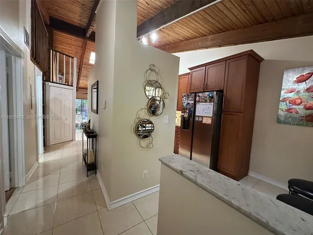 a view of a refrigerator and storage in a room
