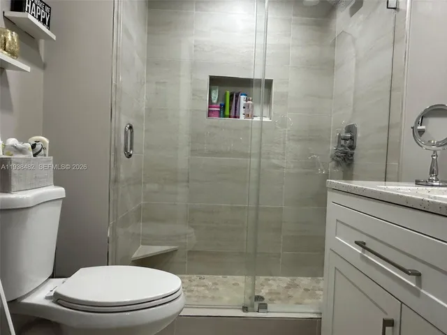 a bathroom with a toilet and a shower