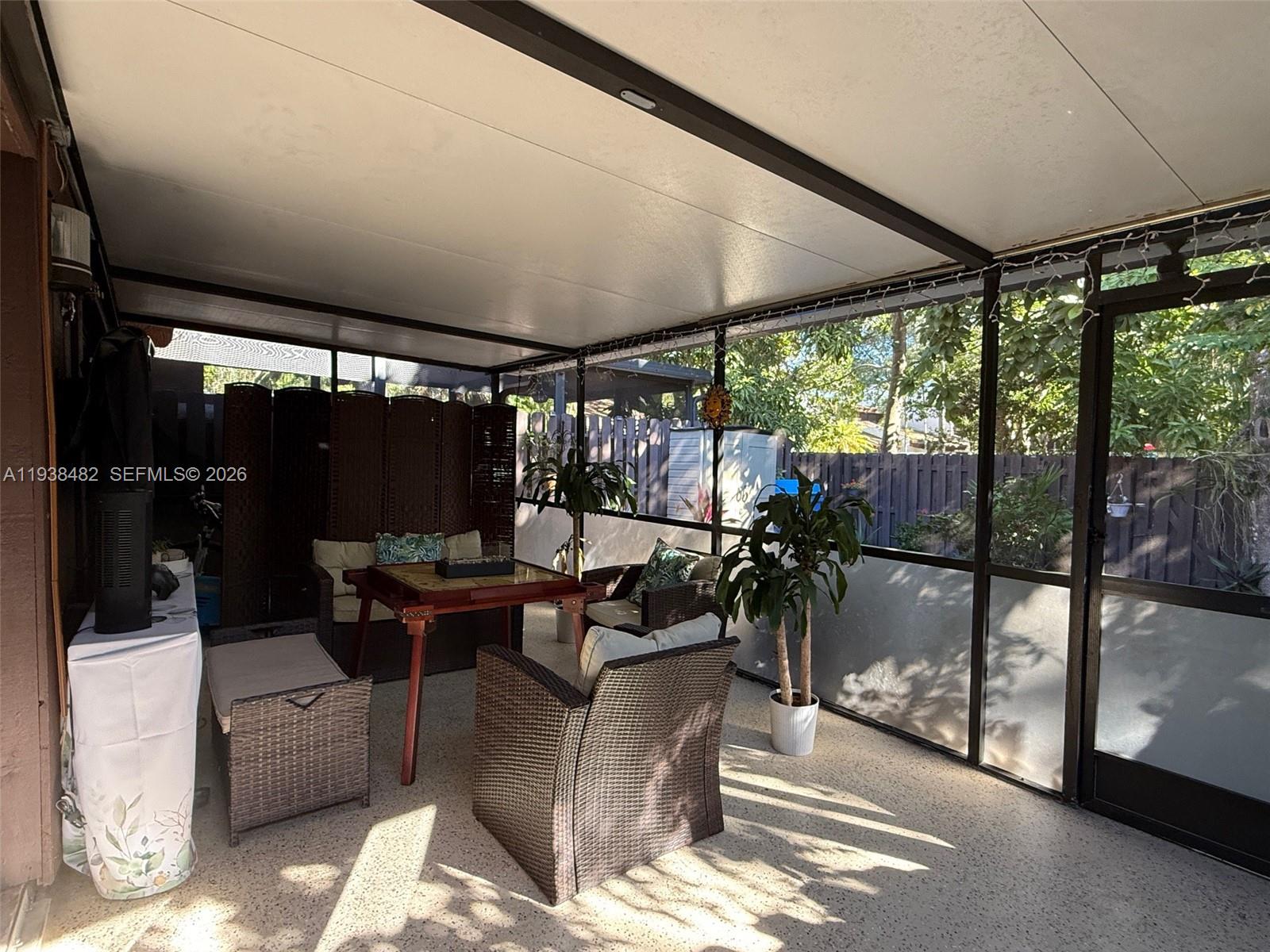 3415 Freedom Drive Hollywood, FL 33021 - Photo 7 of 49 a living room with patio furniture and a floor to ceiling window