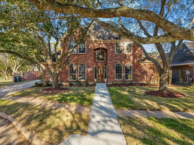 a view of a large building with large trees