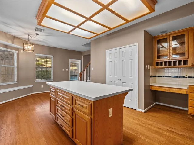 a kitchen that has a stove and a wooden floor