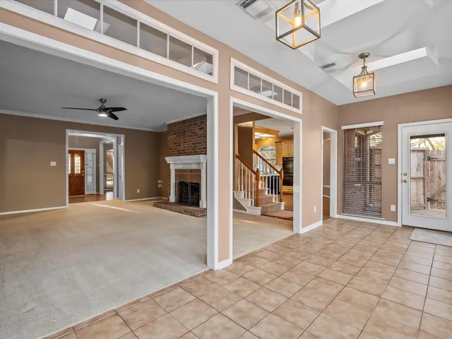 a view of a hallway with wooden floor and chandelier