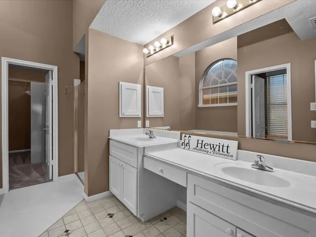 a bathroom with a sink double vanity granite and a mirror