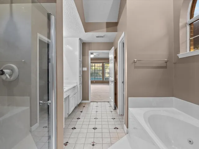 a bathroom with a bathtub and a shower