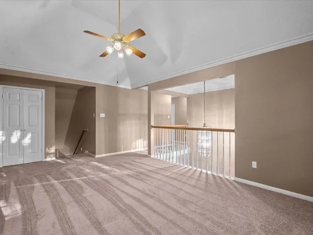 a view of a livingroom with a ceiling fan and window