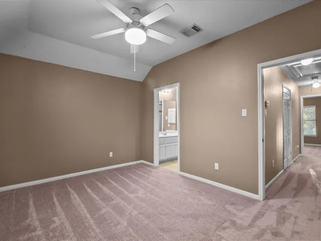 an empty room and chandelier fan