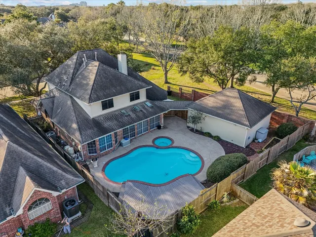 an aerial view of a house with a swimming pool
