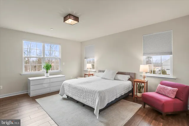 a bed room with a bed and wooden floor